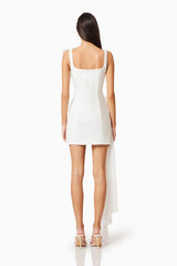 Brunette model wearing Janelle Party Mini Dress In White back shot