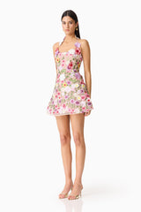 Brunette model wearing The Neve A-Line Mini Dress in Pink Floral side shot