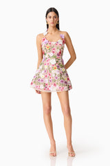 Brunette model wearing The Neve A-Line Mini Dress in Pink Floral posed shot