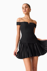 Brunette model wears the Elva Off Shoulder Mini Dress in Black close up shot