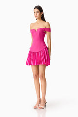 Brunette model wears the Elva Off Shoulder Mini Dress in Pink side shot
