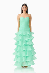 Brunette model wearing the Evelin Tiered Gown in Mint Green front shot