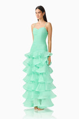 Brunette model wearing the Evelin Tiered Gown in Mint Green side shot