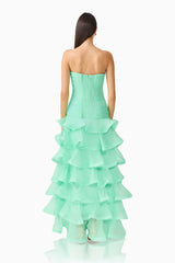 Brunette model wearing the Evelin Tiered Gown in Mint Green back shot