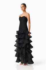 Brunette model wearing the Evelin Tiered Gown in Black side shot