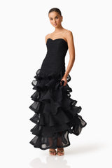 Brunette model wearing the Evelin Tiered Gown in Black posed shot 