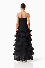 Brunette model wearing the Evelin Tiered Gown in Black back shot 