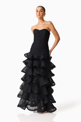 Brunette model wearing the Evelin Tiered Gown in Black posed shot 