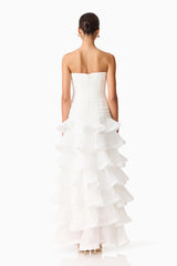 Brunette model wearing the Evelin Tiered Gown in White back shot 