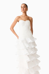 Brunette model wearing the Evelin Tiered Gown in White close up shot 
