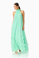 Carla Halter Gown in Mint Green with ruffle hem detailing & relaxed fit posed shot