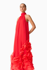 Brunette model wearing the Evelin Halter Gown in Red posed shot 