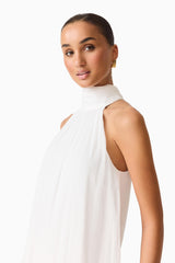 Brunette model wearing the Evelin Halter Gown in White close up shot 