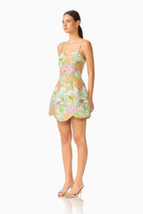 Brunette model wearing the Noralyn Strapless Mini Dress in Green Floral side shot