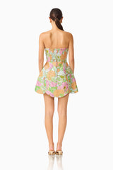 Brunette model wearing the Noralyn Strapless Mini Dress in Green Floral back shot