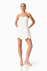 Brunette model wearing the Noralyn Strapless Mini Dress in White posed shot 