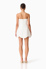 Brunette model wearing the Noralyn Strapless Mini Dress in White back shot 