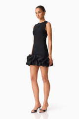 Brunette model wearing the Celia Bubble Mini Dress in Black side shot 