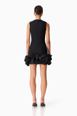 Brunette model wearing the Celia Bubble Mini Dress in Black back shot 