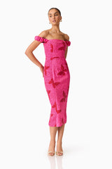 Brunette model wearing the Lorena Jacquard Off Shoulder Midi Dress in Pink posed shot