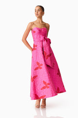 Brunette model wearing The Lorena Jacquard Strapless Gown in Pink posed shot