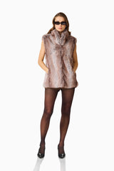 Winona Vest in Brown with collared neckline & sleeveless design posed hands in pockets shot