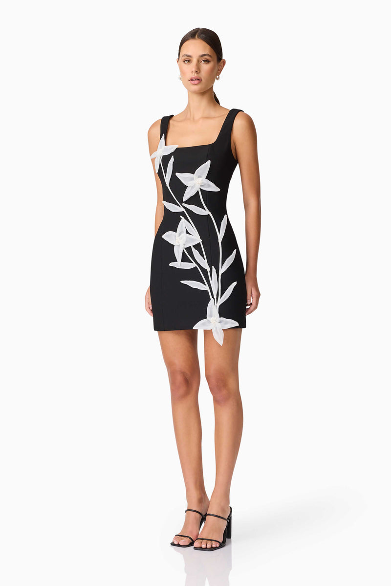 Brunette model wearing ILARIA MINI DRESS in black side shot
