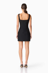 Brunette model wearing ILARIA MINI DRESS in black back shot