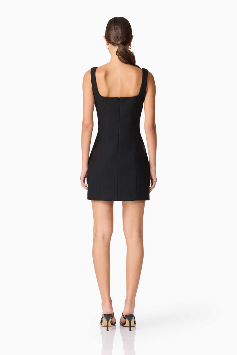 Brunette model wearing ILARIA MINI DRESS in black back shot