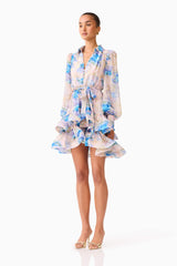 Brunette model wearing Briony Long Sleeve Mini Dress in Pink & Blue Floral side shot