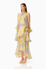 Brunette model wearing the Briony Tiered Gown in Yellow Print side shot