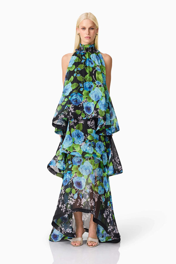 Blonde model wearing the Briony Tiered Gown in Black & Blue Floral front shot