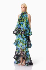 Blonde model wearing the Briony Tiered Gown in Black & Blue Floral side shot