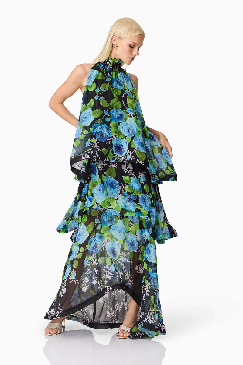 Blonde model wearing the Briony Tiered Gown in Black & Blue Floral posed shot