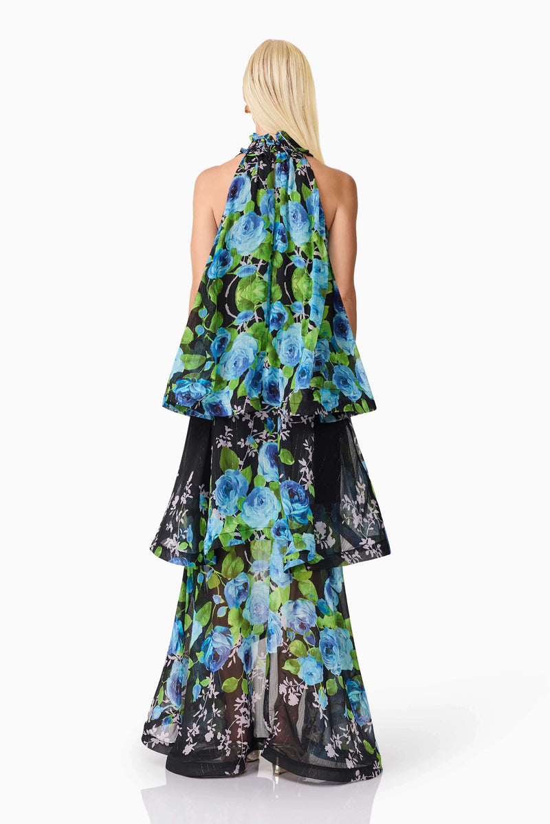 Blonde model wearing the Briony Tiered Gown in Black & Blue Floral back shot
