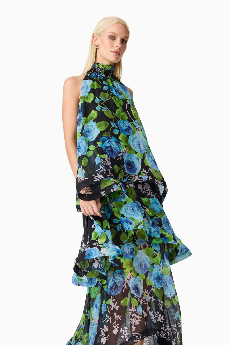 Blonde model wearing the Briony Tiered Gown in Black & Blue Floral close up shot
