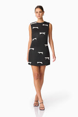 Brunette model wearing Ursula Mini Shift Dress in Black posed shot