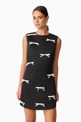 Brunette model wearing Ursula Mini Shift Dress in Black close up shot