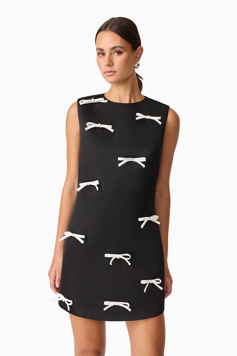 Brunette model wearing Ursula Mini Shift Dress in Black close up shot