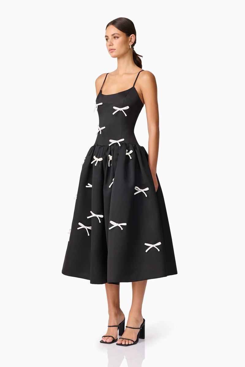 Brunette model wearing Ursula A-Line Midi Dress in Black side shot