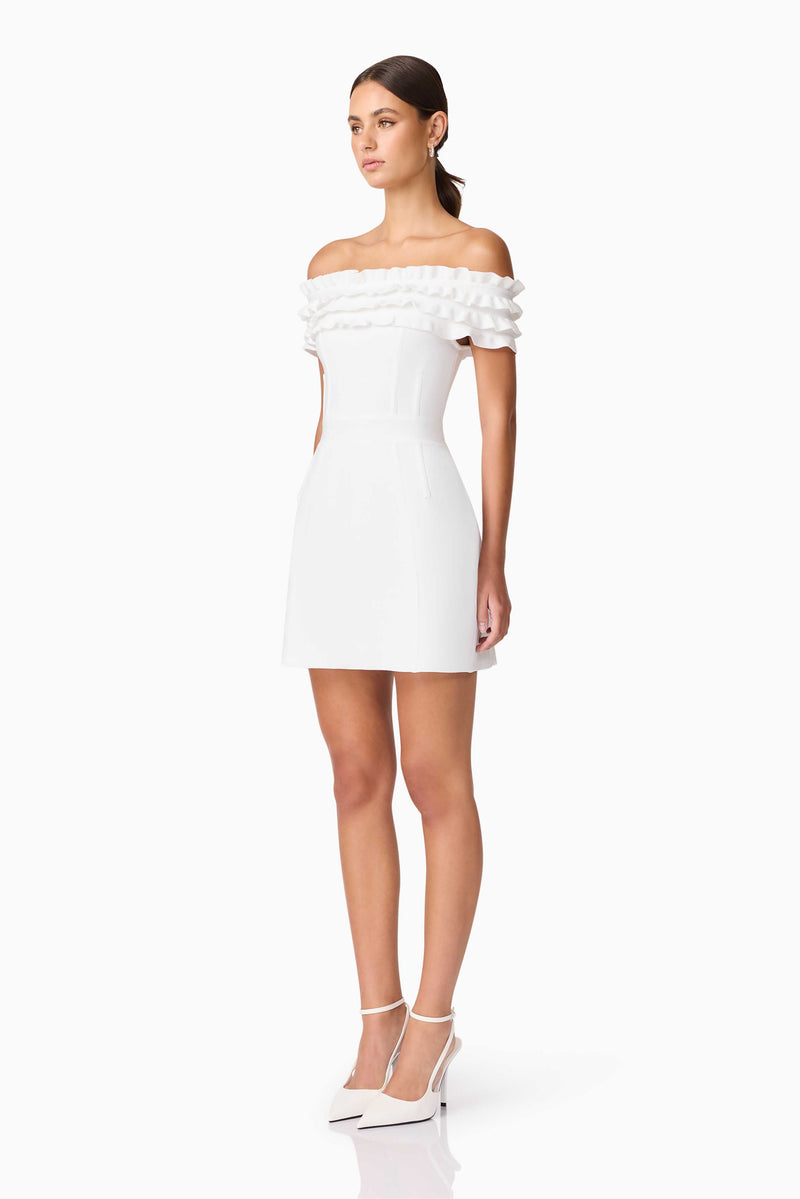 Brunette model wearing Sonya Off The Shoulder Mini Dress in White side shot