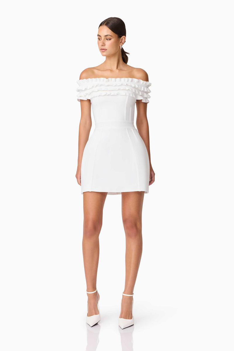 Brunette model wearing Sonya Off The Shoulder Mini Dress in White posed shot