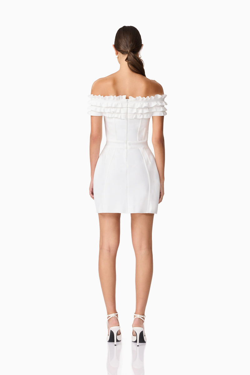 Brunette model wearing Sonya Off The Shoulder Mini Dress in White back shot