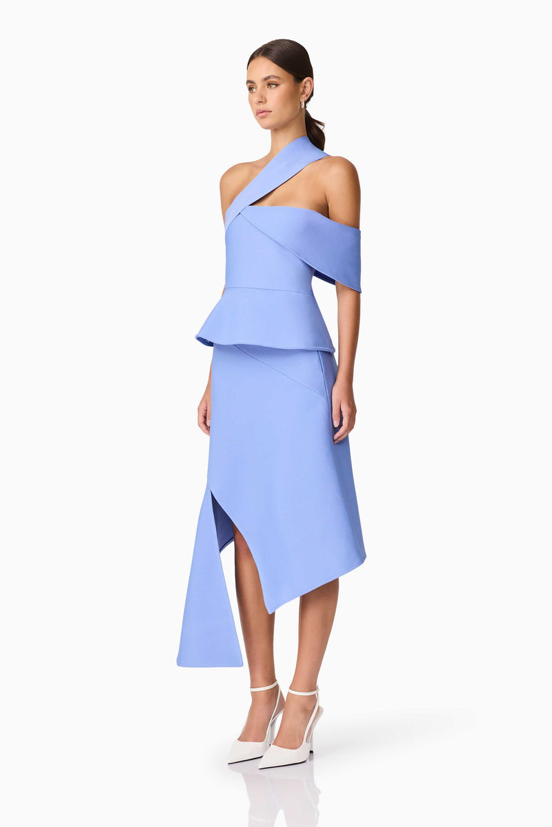 Brunette model wearing Sonya Asymmetrical Set in Blue side shot