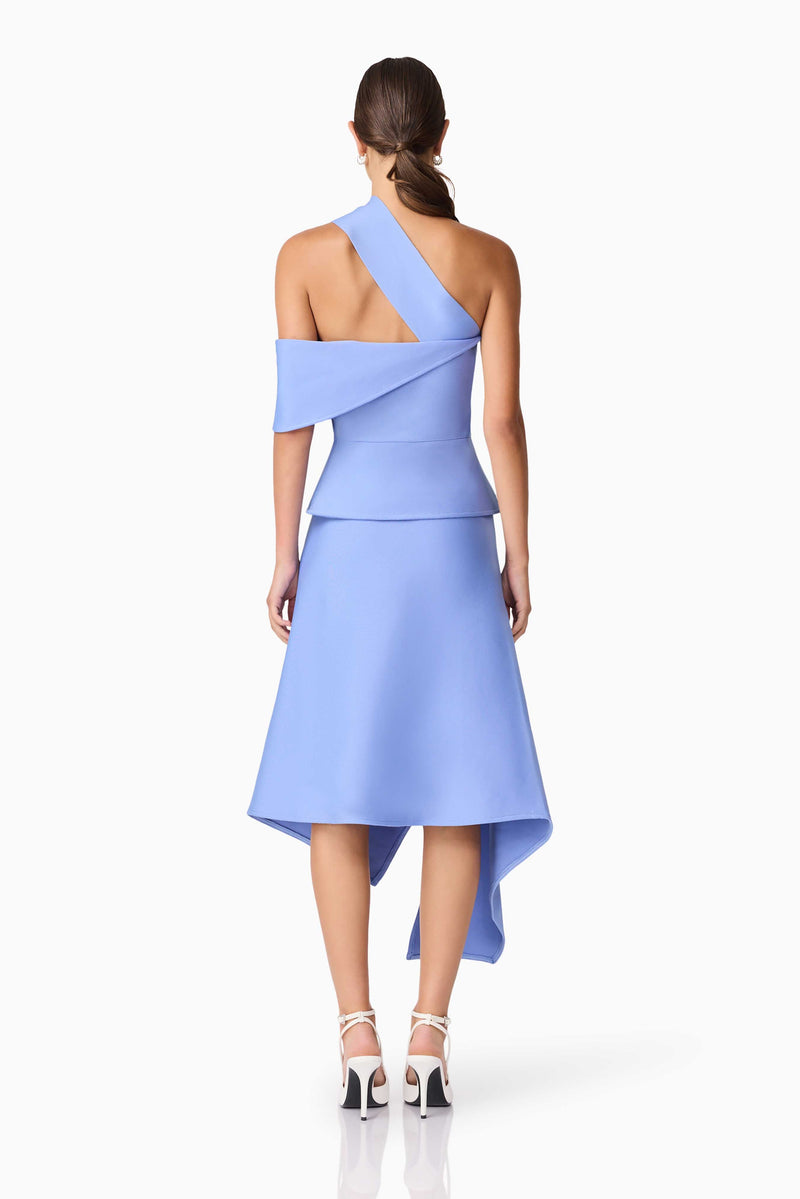 Brunette model wearing Sonya Asymmetrical Set in Blue back shot