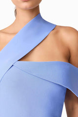 Brunette model wearing Sonya Asymmetrical Set in Blue detail shot