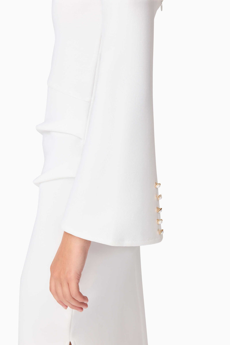 Brunette model wearing Sonya Long Sleeve Midi Dress in White detail shot