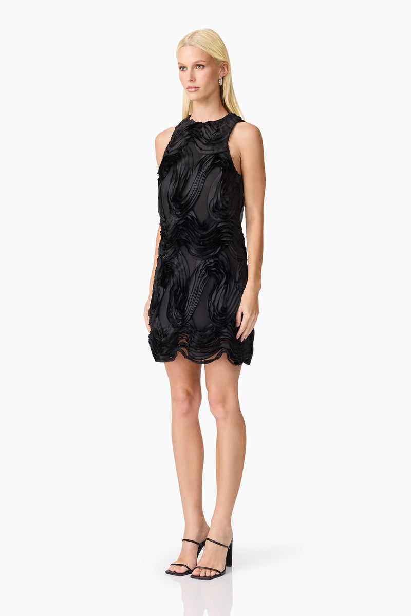 Blonde model wearing Asher Mini Shift Dress in Black side shot