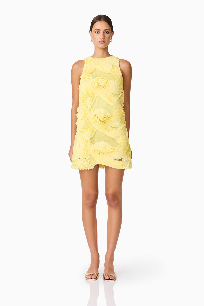 Brunette model wearing Asher Mini Shift Dress in Yellow front shot