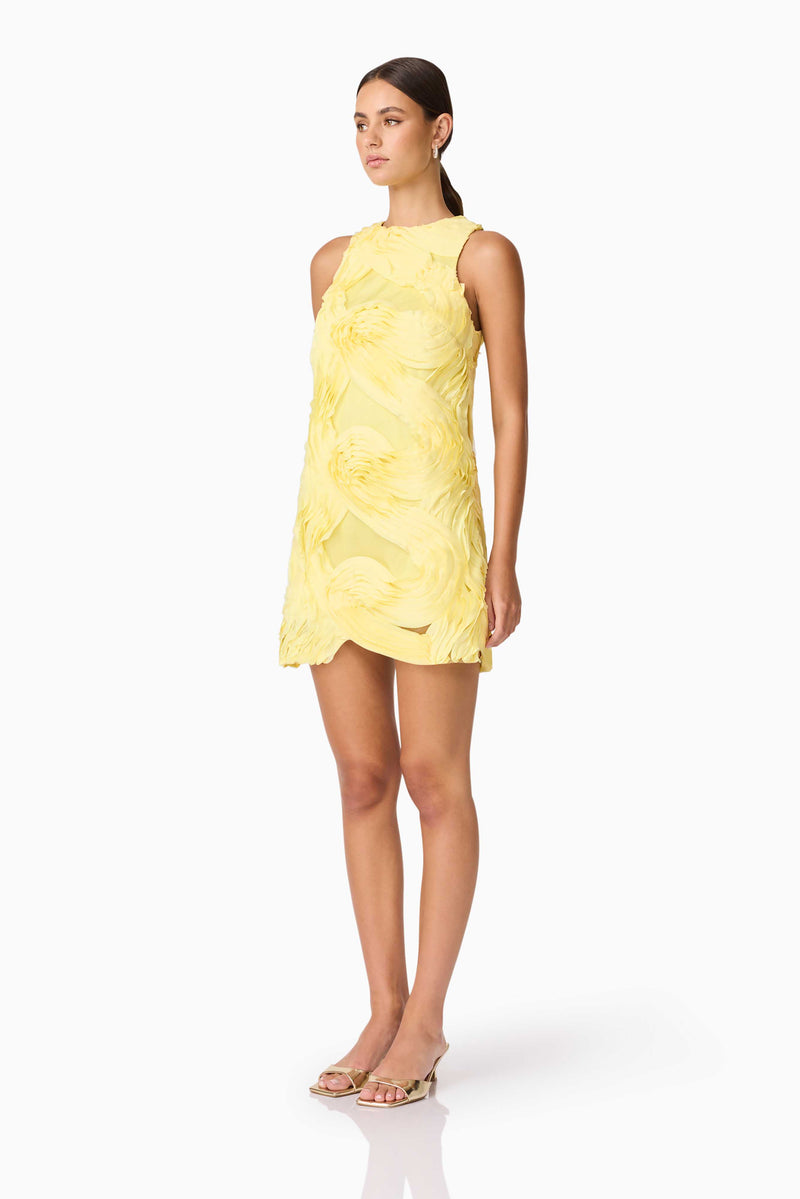 Brunette model wearing Asher Mini Shift Dress in Yellow side shot